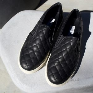 Black slip on sneakers by Steve Madden
